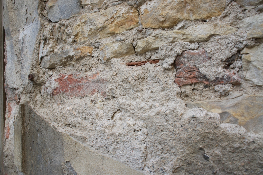 Crumbling plaster and roughly cut stone